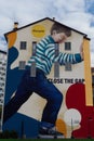 Milan, Italy Colorful wall graffiti under blue sky.