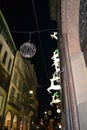 Running white deers and the street golden clock of the Rolex boutique decorated for the Christmas holidays.