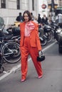 Female wearing a red fancy suit, black handbag and pink elegant shoes Royalty Free Stock Photo