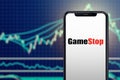 Milan, Italy: February 26, 2021: Gamestop retail company logo on the smartphone and its authentic stock price chart for
