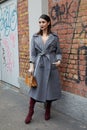 MILAN, ITALY - FEBRUARY 22, 2023: Heart Evangelista with gray Fendi coat before Fendi fashion show, Milan Fashion Week street