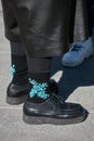 Man with black socks with turquoise embroidery with beads before Marco Rambaldi fashion show,