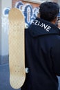 Man with Louis Vuitton skateboard and black Celine hoodie before Fendi fashion show, Milan
