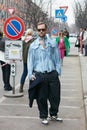 Man with pale blue silk shirt and denim trousers before Emporio Armani fashion show, Milan