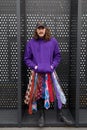 MILAN, ITALY - FEBRUARY 24, 2023: Man with purple hoodie, ties skirt and Givenchy cap before Gucci fashion show, Milan Fashion