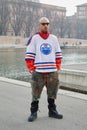 MILAN, ITALY - FEBRUARY 24, 2023: Man with white, blue, red Oilers shirt and camouflage military shorts before Sportmax fashion