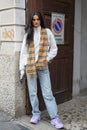 Top model with beige Burberry scarf and purple Balenciaga sneakers before Genny fashion show,