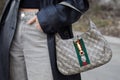MILAN, ITALY - FEBRUARY 24, 2023: Woman with Balenciaga Gucci bag before Sportmax fashion show, Milan Fashion Week street style