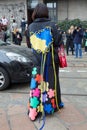 MILAN, ITALY - FEBRUARY 24, 2023: Woman with black coat with yellow and blue heart with strings before Sportmax fashion show,