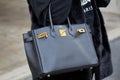 Woman with black leather Hermes bag before Genny fashion show, Milan Fashion Week street style