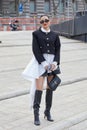 Woman with black and white dress and Yves Saint Laurent bag before Ermanno Scervino fashion Royalty Free Stock Photo