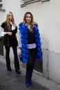 MILAN, ITALY - FEBRUARY 26, 2023: Woman with blue fur coat and striped shirt before Luisa Spagnoli fashion show, Milan Fashion