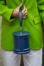 Woman with blue leather bag and green jacket before Genny fashion show, Milan Fashion Week