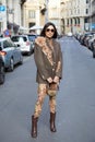 MILAN, ITALY - FEBRUARY 25, 2023: Woman with brown jacket with floral decoration and Gucci bag before Missoni fashion show, Milan