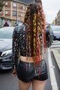 Woman colorful braids and Philipp Plein black leather jacket before Gucci fashion show, Milan