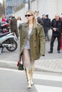 MILAN, ITALY - FEBRUARY 23, 2023: Woman with grey, green leather jacket and golden boots before Prada fashion show, Milan Fashion