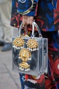 MILAN, ITALY - FEBRUARY 25, 2023: Woman with silver bag with golden face details before Missoni fashion show, Milan Fashion Week