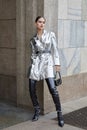 Woman with silver metallic jacket and grey boots before Genny fashion show, Milan Fashion Week