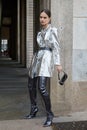 Woman with silver metallic jacket and grey boots before Genny fashion show, Milan Fashion Week