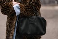 Milan, Italy - February 22, 2023: woman wearing Miu Miu shoulder bag. Fashion blogger outfit details