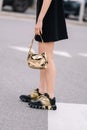 Milan, Italy - February 23, 2023: woman wearing Prada cleo golden shoulder bag. Fashion blogger outfit details Royalty Free Stock Photo