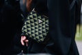 Milan, Italy - February 23, 2023: woman wearing Prada Symbole shoulder bag. Fashion blogger outfit details