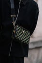 Milan, Italy - February 23, 2023: woman wearing Prada Symbole shoulder bag. Fashion blogger outfit details