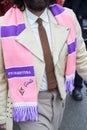 Man with beige leather jacket and purple and pink Fiorentina scarf before Etro fashion show,