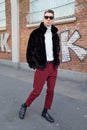Man with black fur jacket and white turtleneck before Fendi fashion show, Milan Fashion Week