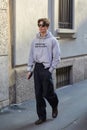 Man with grey Helmut Lang hoodie and black trousers before Giorgio Armani fashion show, Milan Royalty Free Stock Photo