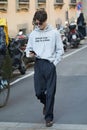 Man with grey Helmut Lang hoodie and black trousers before Giorgio Armani fashion show, Milan Royalty Free Stock Photo