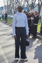 Man with light blue shirt and black trousers before Emporio Armani fashion show, Milan Fashion