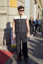 Man with MSGM black and white sleeveless puffer jacket and black cargo trousers before MSGM