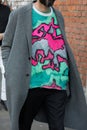 Man with pink and turquoise sweater and gray coat before Fendi fashion show, Milan Fashion Week