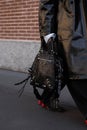 Milan, Italy - January, 13, 2024: man wears Balenciaga black bag, street style details, fashion detail Royalty Free Stock Photo