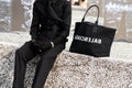 Milan, Italy - January, 10, 2024: man wears Balenciaga jumbo tote bag, street style details, fashion detail Royalty Free Stock Photo