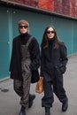 Man and woman with brown and black overalls before Marco de Vincenzo fashion show, Milan Fashion