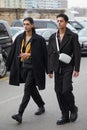 Men with black jacket and trousers before Prada fashion show, Milan Fashion Week street style Royalty Free Stock Photo