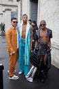 Men with light blue sheepskin jacket and black leather shirt and shorts before Prada fashion show Royalty Free Stock Photo