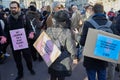 People with pink colored hands demonstrate against fashion and pollution before Salvatore