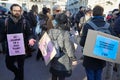 People with pink colored hands demonstrate against fashion and pollution before Salvatore