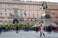 People relax on the main square of Milan - Piazza del Duomo near the monument to the first king of Italy Vittorio Emanuele II