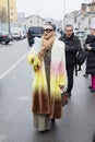 Woman with fur coat with soft gradient in white, pink, yellow and brown colors before Etro