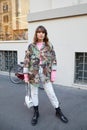 Woman with John Richmond green and brown camouflage shirt before John Richmond fashion show,