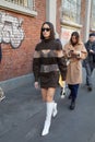 Woman with transparent Fendi dress and white leather boots before Fendi fashion show, Milan