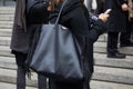 Woman with Victoria Secret black leather bag with fringes before Frankie Morello fashion show,