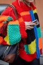 Woman with wool jacket in red, green, yellow, and blue colors before Etro fashion show, Milan