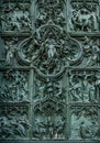 Milan/Italy - July 10, 2016: Detail of the beautiful bas-reliefs on the main bronze door of Milan Cathedral, famous tourist Royalty Free Stock Photo