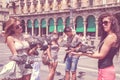 girls feed pigeons in Piazza del Duomo, toned.