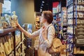 Milan, Italy. July, 8 2019: Young lady in the supermarket doing shopping Royalty Free Stock Photo